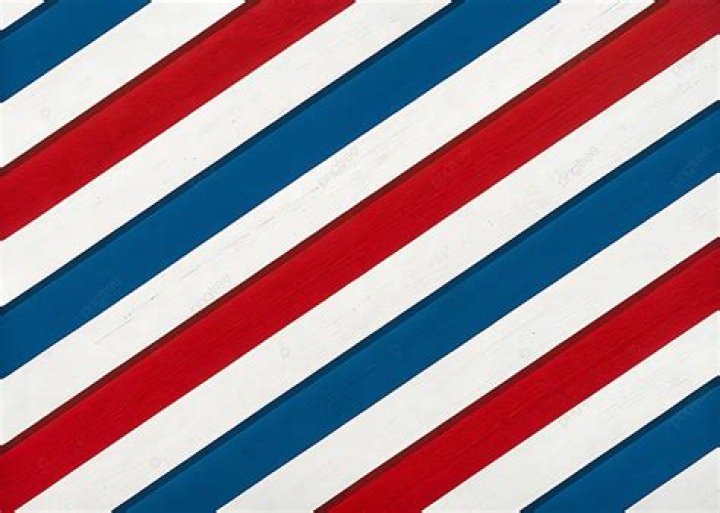 What does the red stripe on a barber pole represent?